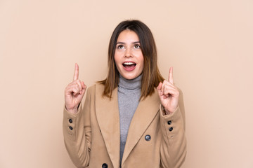 Young woman over isolated background pointing with the index finger a great idea