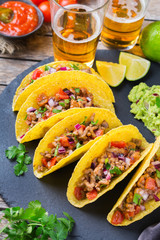 Taco shell nachos with beef, guacamole, chili, cheese salsa, tequila