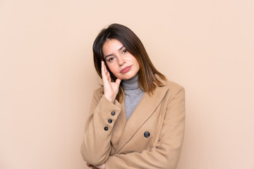 Young woman over isolated background unhappy and frustrated