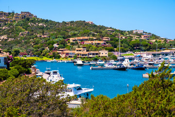 Fototapeta na wymiar Porto Cervo, Sardinia, Italy - Panoramic view of luxury yacht port, marina and residences of Porto Cervo resort at the Costa Smeralda coast of Tyrrhenian Sea