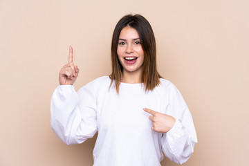 Young woman over isolated background with surprise facial expression