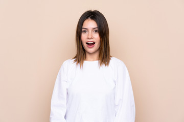 Fototapeta premium Young woman over isolated background with surprise facial expression