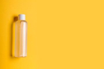 Bottle of antiseptic hand gel isolated on yellow