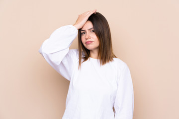 Young woman over isolated background having doubts with confuse face expression