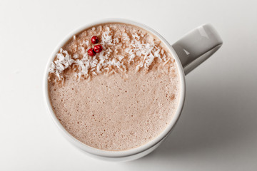 Craft latte coffee with coconut powder on top in white ceramic mug. White background. Best for commercial. Content for coffee addicted guys