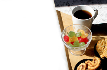 A cup of tea with cookies and sweets. Place to insert text. Breakfast or snack concept.