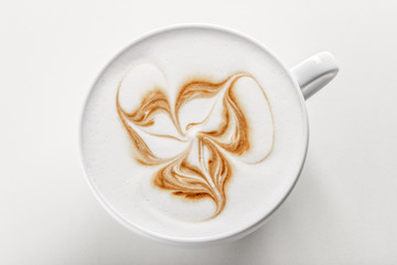 Hot cappuccino with latte art on top in white ceramic mug. White background. Best for commercial.