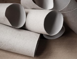 Structure made out of toilet paper rolls with a wood background. In times of lack of toilet paper because of the covid 19.