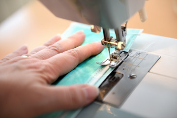 Woman sewing medical mask