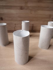 Structure made out of toilet paper rolls with a wood background. In times of lack of toilet paper because of the covid 19.