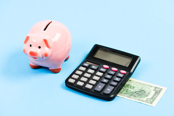 Credit debt concept. Economics and profit management. Economics and finance. Piggy bank money savings. Piggy bank pink pig and calculator. Exchange rates. Economics and business administration