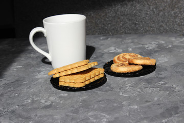 A cup of tea with cookies and sweets. Place to insert text. Breakfast or snack concept.