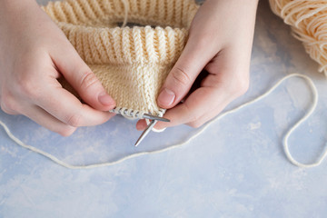 Obraz na płótnie Canvas knitting needles close up needlework on a soft light blue background