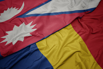waving colorful flag of romania and national flag of nepal.