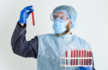 Scientist test tubes with blood samples. Detection of antibodies. Detection of virus. Man work at...