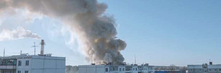 Fire in town. Burning fire with black and white smoke under house. Stok banner photo.