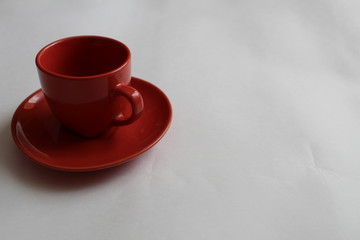 blue or red Cup mug with saucer on a white background there are green and red mugs at the back with a place to insert text