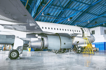 The aircraft is in the aviation hangar. Theme repair and maintenance of airplane airlines.