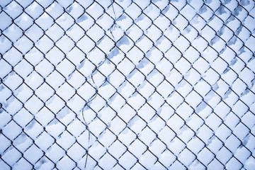 A Winter mesh on nature in the park background. Winter fence fence.