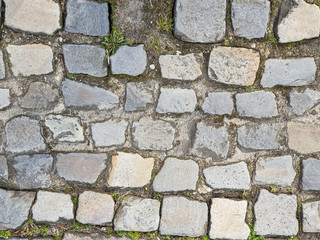 Background texture paving stones or cobblestones on the sidewalk in the street 