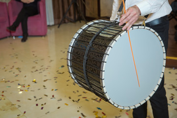 Musicians march, play and make music with large bass drums . Drummer performance musicians play the...