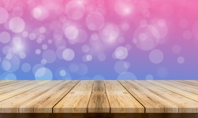 Empty wooden table with a beautiful colour bokeh background