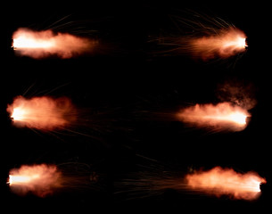 A shot from a firearm on a black background, a fiery exhaust with flying sparks, flames bursting out of the pipe - 336506924