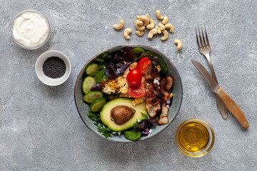 Omelette with bacon, tomatoes, avocado and olive oil. Healthy fats concept.