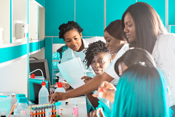 African medics, technical assistants, scientists, young women work in research laboratory, medical...