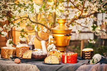 Traditional russian Easter cottage cheese dessert. Orthodox paskha, kulich cakes on table.