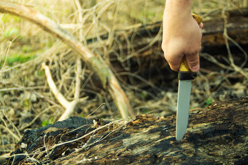knife in hand outdoor shot 