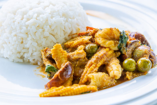 Asian Spicy Hot Food Or Thai Food, Closeup Side View Above Shrimp Green Curry Baby Corn And Coconut Milk Fried With White Cooked Rice On Clean Round White Plate Background For Cooking Delicious Meals