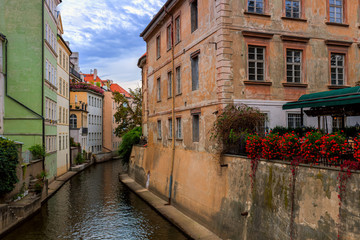 Fototapeta na wymiar Narrow canal among old houses in Prague, Czechia.