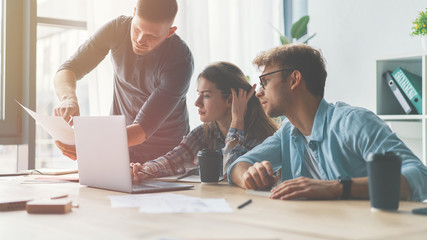 Group of business people discussing questions at meeting in office