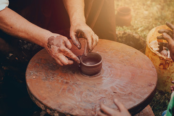 hands make a clay mug