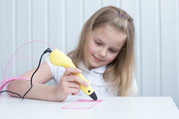 The girl is engaged with a 3D pen. Light background. Selective focus. Classes at home.