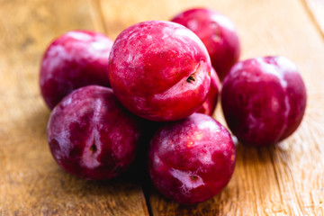 Brazilian plum on rustic wooden background, image of tropical fruit.