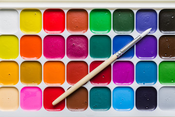 colorful background of watercolor aquarelle paint and clean brush