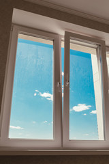 Double-glazed plastic double-glazed window is open for fresh air for ventilation - room ventilation during repair