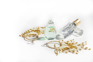 Long beaded earrings and oily perfumes. The promise of a hot summer. Perfumes and jewelry. Holiday season.
