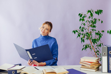 business woman working at a desk in the office with books training