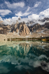 passu cones Karakoram mountain range reflection mirror lake cloudy