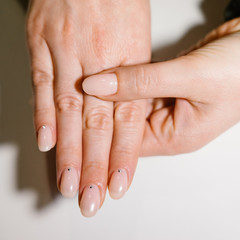 Woman's hand with pink nails - obrazy, fototapety, plakaty