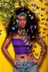 Fototapeta na wymiar beautiful african girl surrounded by butterflies