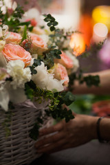 Vertical shot of beautiful fresh flowers bouquet designed in basket.