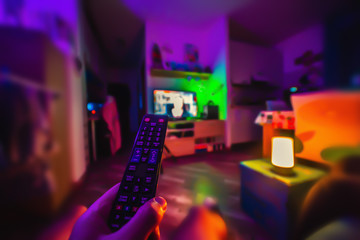 Man watching tv in a colorful living room