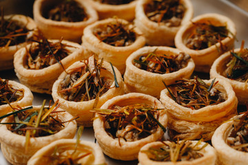 Appetizer with mushrooms and vegetables. puff pastry baskets. Catering. coffee break. close up.