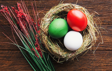 Happy Easter holiday Italian card, Easter eggs as the color of the Italy flag in nest