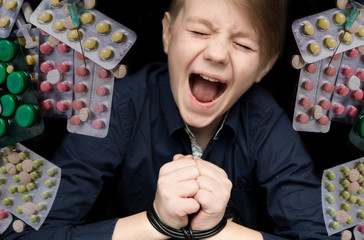 Dramatic portrait. Concept of anxiety and fear. Cute teenage boy have phobia of medicine, syringes...