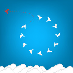 Think differently concept. Be different. Red bird changing direction. New idea, change, trend, courage, creative solution, innovation and unique way concept	